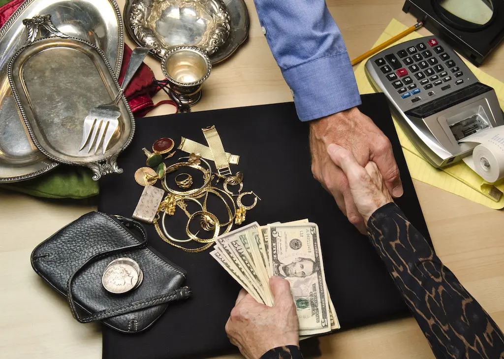 Person selling their gold and silver jewelry