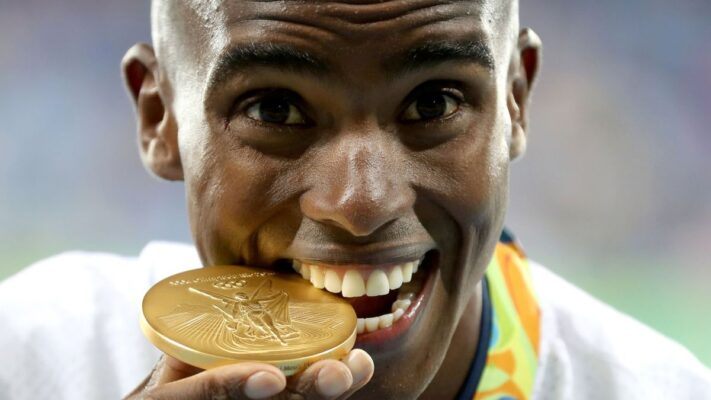 Mo Farah bites his Olympic gold in Rio (Image courtesy of Owen Humphreys/PA Wire).